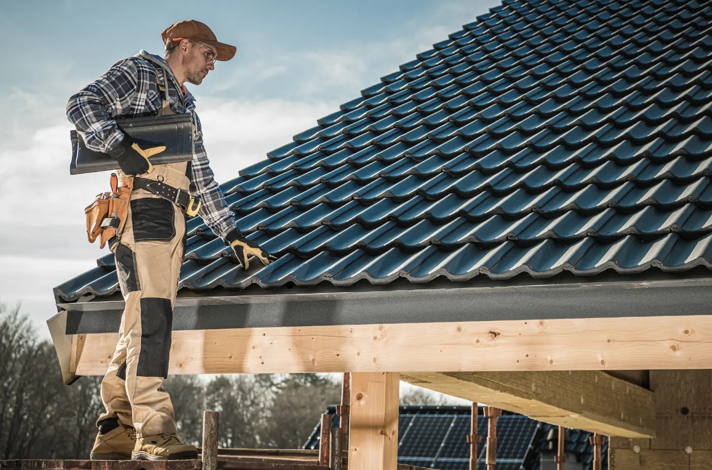 A worker catching shingles checking tiles installation